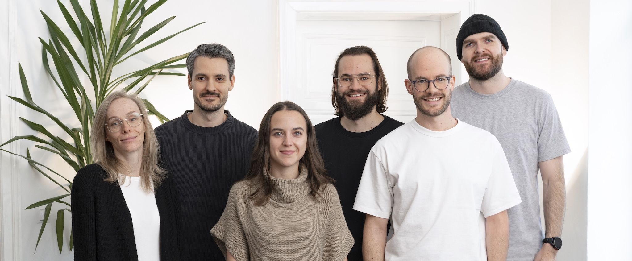 The six-person loomobox team standing together in their bright office