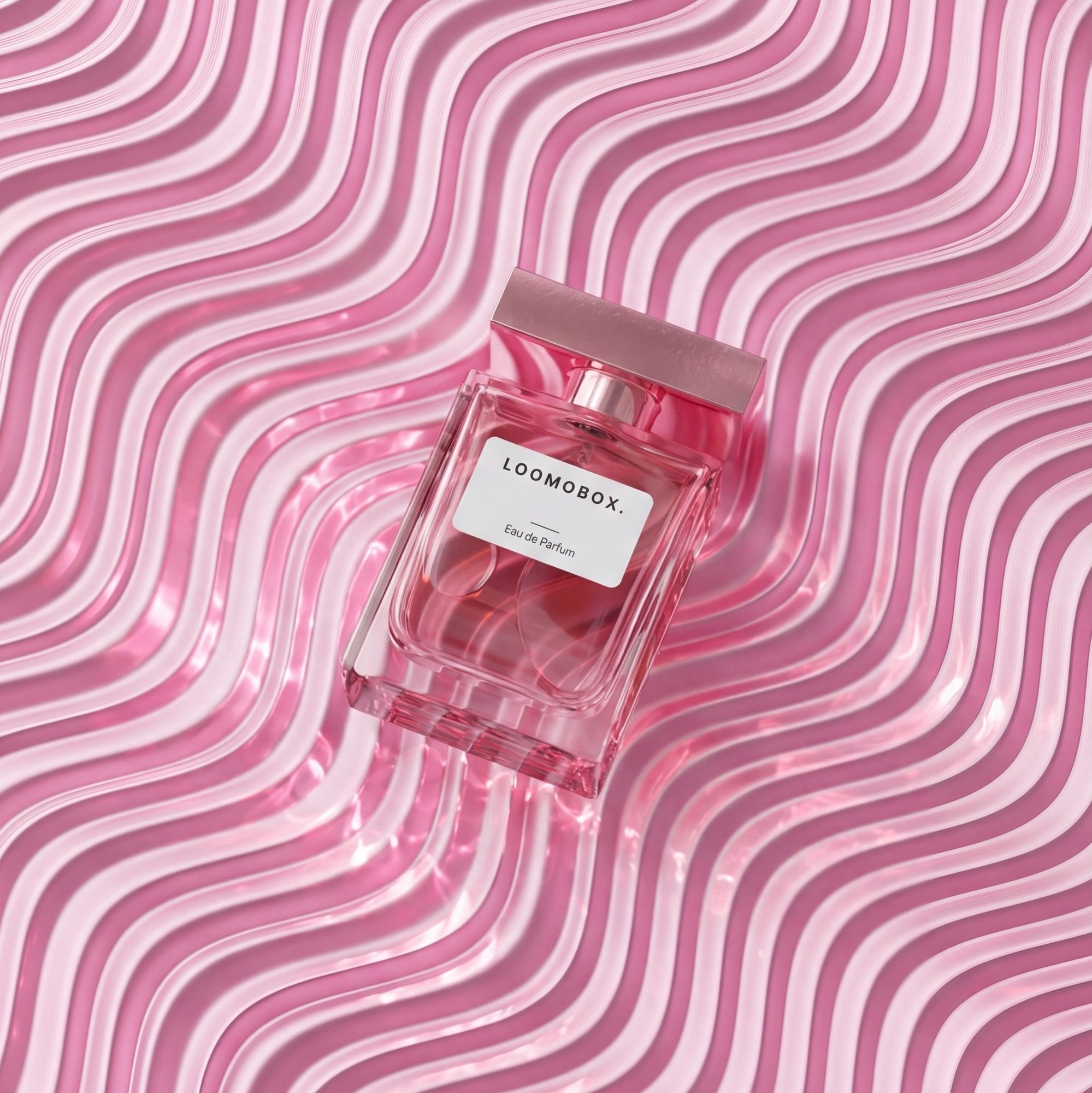 Pink eau de parfum flacon lying on glossy wavy pink ridges — playful fragrance product photography created with loomobox