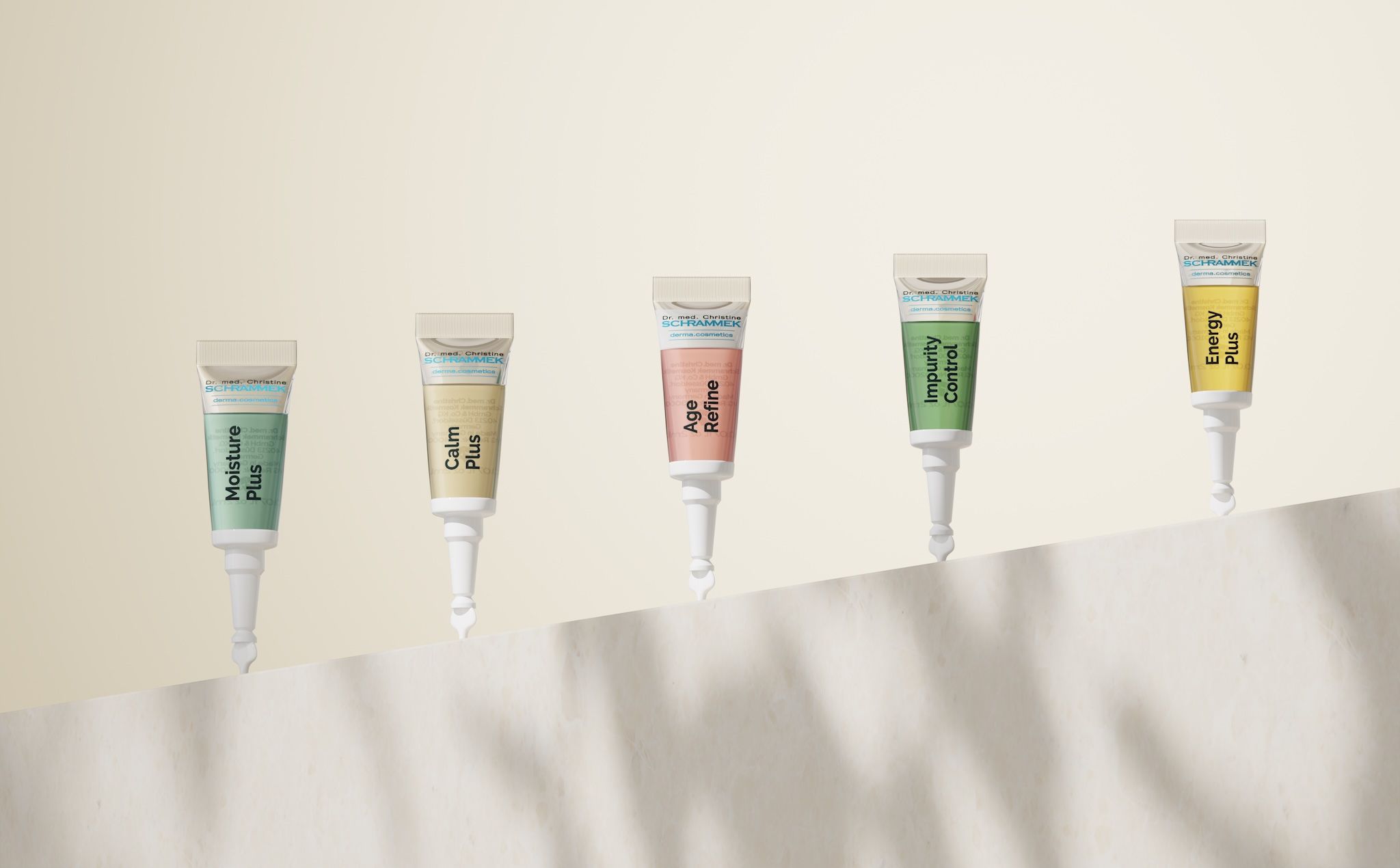Five Dr. Schrammek ampoules — Moisture Plus, Calm Plus, Age Refine, Impurity Control and Energy Plus — ascending along a stone edge against a beige background