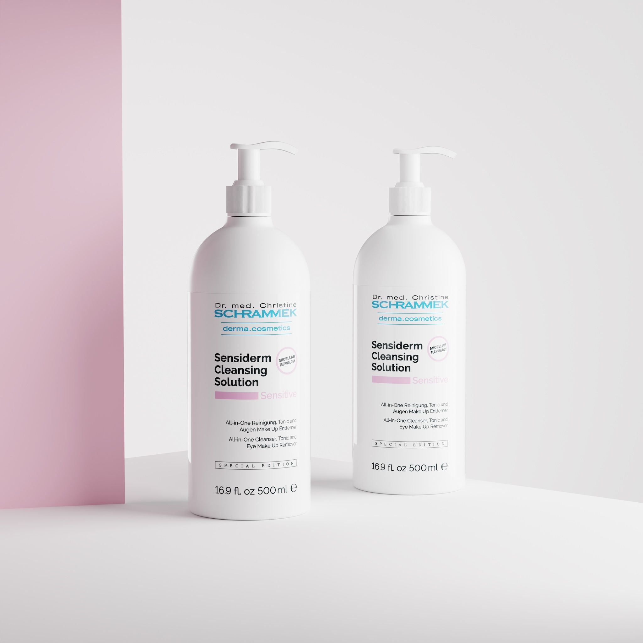 Two Dr. Schrammek Sensiderm Cleansing Solution 500 ml dispensers in a white studio corner with a pink wall