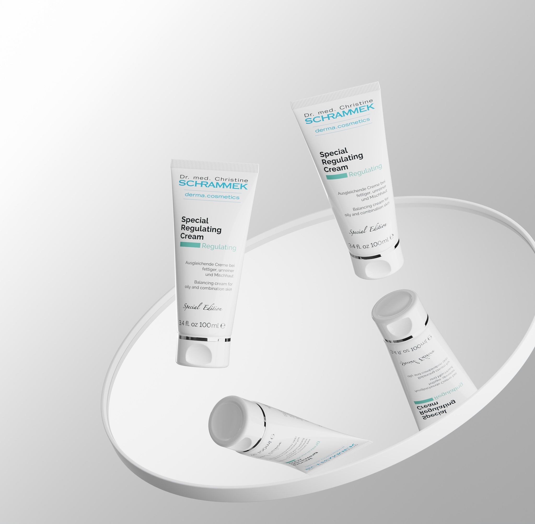 Four Dr. Schrammek Special Regulating Cream tubes floating above a round white surface