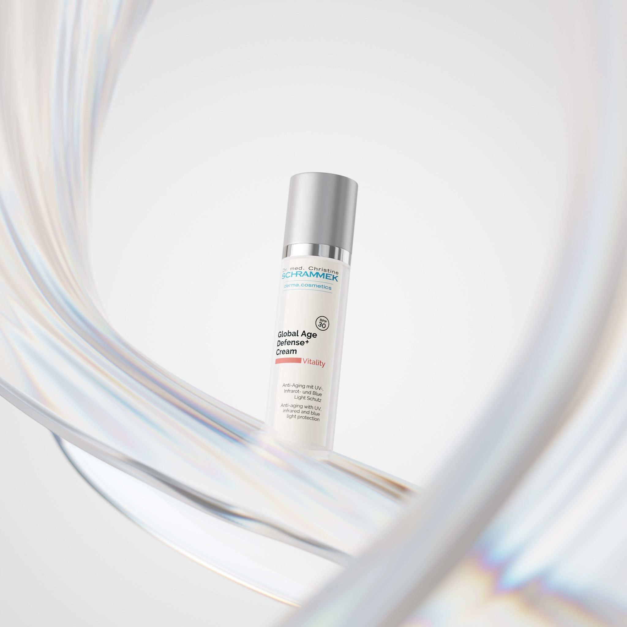 Dr. Schrammek Global Age Defense+ Cream surrounded by a shimmering, translucent ribbon